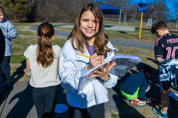 girl smiling while using notebook